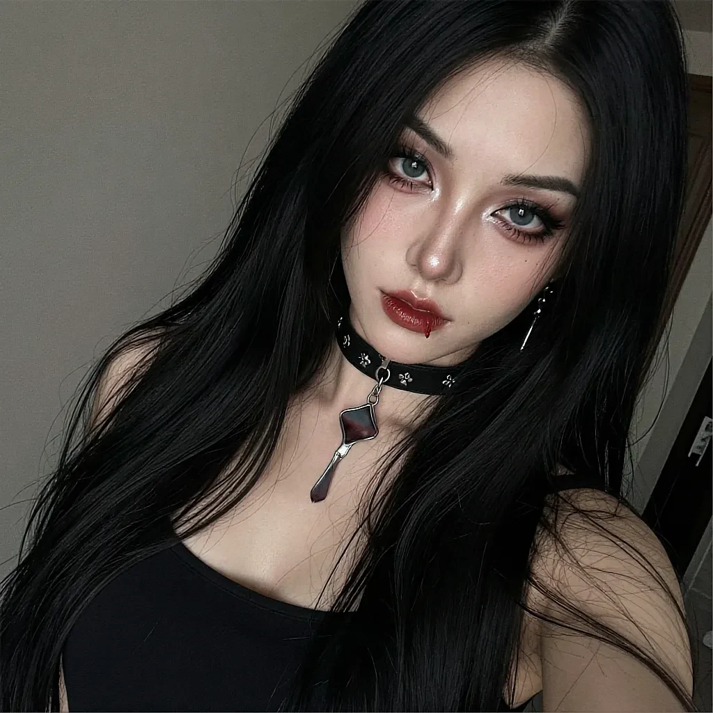 Long black-haired woman with blue eyes and red lips wearing a studded choker with pendant